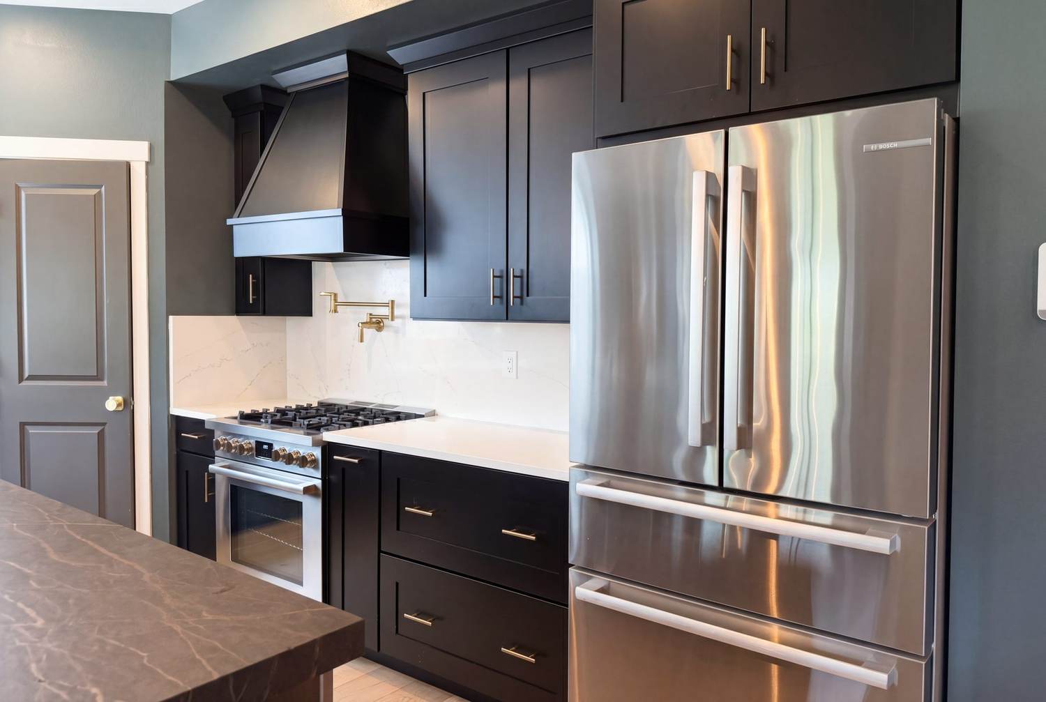 Kitchen wide shot — custom cabinetry, island, and Bosch appliances