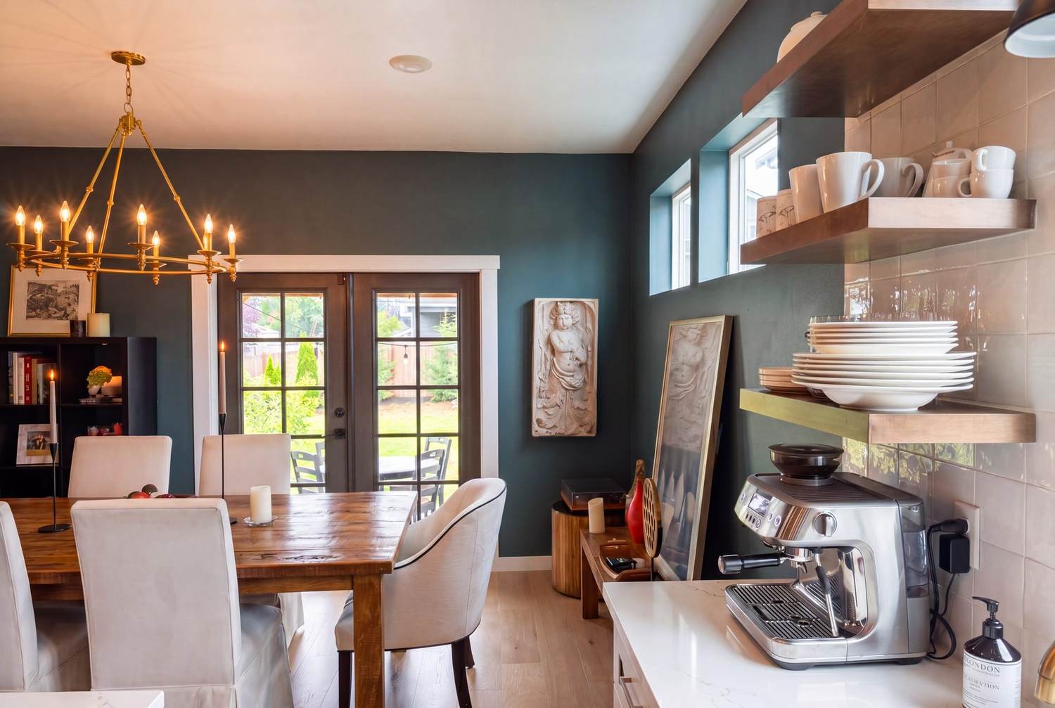 Dining area with open shelving beside the French doors